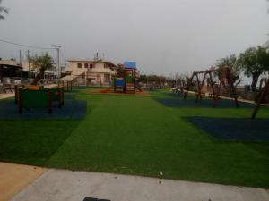 a park with an empty playground with a swing at Cozy house 2 in Vrachati