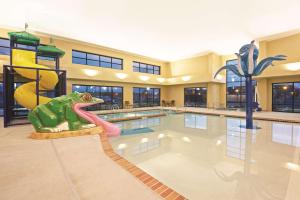 a swimming pool with a dinosaur in the middle of it at La Quinta by Wyndham Billings in Billings