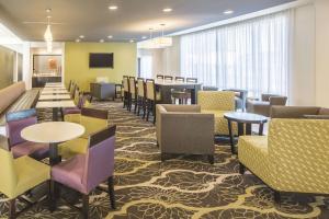 a restaurant with tables and chairs in a room at La Quinta by Wyndham Hattiesburg - I-59 in Hattiesburg
