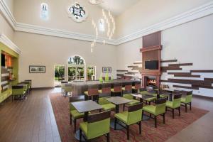 a restaurant with tables and chairs and a fireplace at La Quinta by Wyndham Conference Center Prescott in Prescott