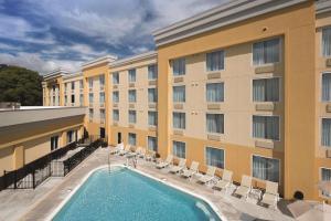 a hotel with a pool in front of a building at La Quinta by Wyndham Lynchburg at Liberty Univ. in Lynchburg