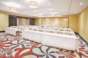 une salle de conférence avec des rangées de tables et de chaises dans l'établissement La Quinta by Wyndham Hinesville - Fort Stewart, à Hinesville