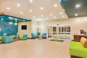 a large lobby with green and blue furniture in a hospital at La Quinta by Wyndham Cotulla in Cotulla