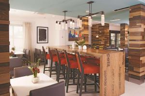 a kitchen and dining room with a large wooden table and chairs at La Quinta by Wyndham Atlanta Airport North in Atlanta