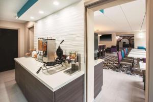 a lobby with a reception counter and a dining room at La Quinta by Wyndham Sturbridge in Sturbridge