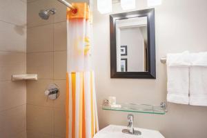 a bathroom with a shower curtain and a sink at La Quinta by Wyndham New York City Central Park in New York +37 photos