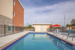 a swimming pool in front of a building at La Quinta by Wyndham Cullman in Cullman