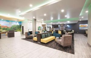 a lobby with couches and chairs in a hospital at La Quinta by Wyndham Tulsa Broken Arrow in Broken Arrow