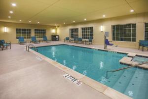 a large swimming pool with blue chairs and tables at La Quinta by Wyndham Colorado City in Colorado City
