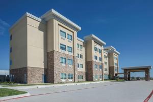 a large apartment building with a street in front at La Quinta by Wyndham Kingsville in Kingsville