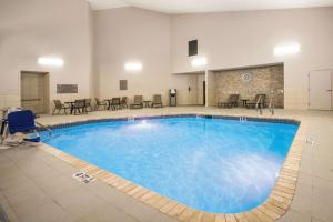 a large pool in a room with tables and chairs at La Quinta by Wyndham Chattanooga-Hamilton Place in Chattanooga