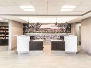 a lobby with a large painting on the wall at La Quinta Inn & Suites by Wyndham Walla Walla in Walla Walla