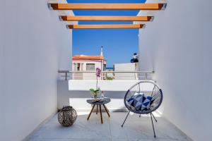 a balcony with a chair and a table at Ikia Aretousa in Kato Daratso