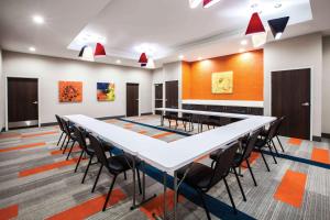 a conference room with a long table and chairs at La Quinta by Wyndham Owasso in Owasso +39 photos