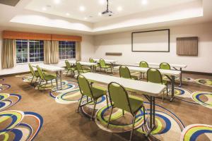 a classroom with tables and chairs in a room at La Quinta by Wyndham St. Paul-Woodbury in Woodbury +55 photos