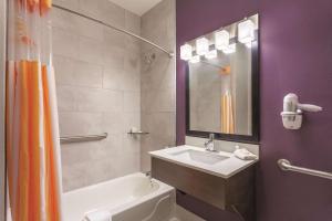 a bathroom with a sink and a tub and a shower at La Quinta by Wyndham Hopkinsville in Hopkinsville