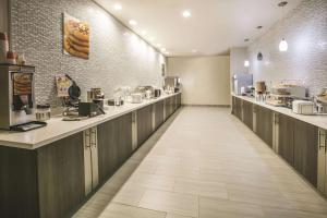 a restaurant with a long corridor with aasteryasteryasteryasteryasteryasteryasteryastery at La Quinta by Wyndham Dallas - Richardson in Dallas