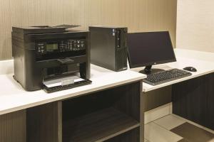 a desk with a computer and a monitor and keyboard at La Quinta by Wyndham Colorado City in Colorado City