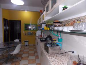 a kitchen with a sink and a counter top at Hostel São José Dos Campos in São José dos Campos