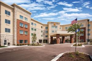 a rendering of the front of a hotel with a parking lot at La Quinta by Wyndham St. Paul-Woodbury in Woodbury