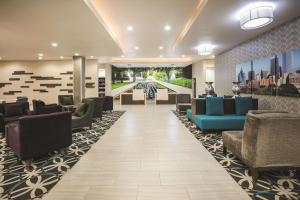 a lobby with couches and chairs in a building at La Quinta by Wyndham Dallas - Richardson in Dallas
