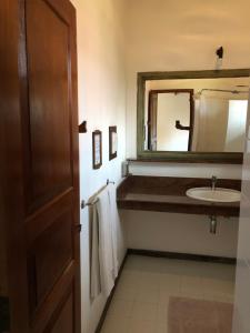 a bathroom with a sink and a mirror at Villa Araliya in Negombo