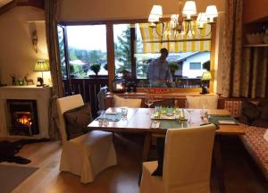a dining room with a table and a fireplace at Apartment Cristina - Südbalkon mit Bergblick in Seefeld in Tirol
