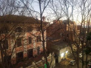 a view of a building with trees in the foreground at Open Space Aldobrandini in Lido di Ostia