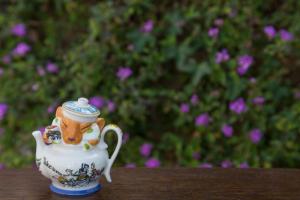 a small tea pot sitting on top of a table at Cheshire Cat Inn & Cottages in Santa Barbara