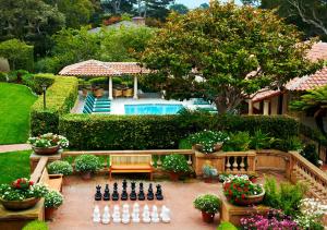a garden with a chess board in front of a house at La Playa Hotel in Carmel