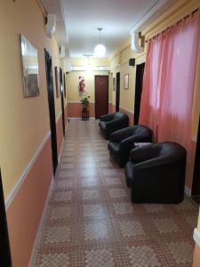 a hallway with couches and chairs in a room at Hotel Paris in General San Martín