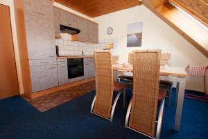 a kitchen with a table and chairs in a room at 50134... in Carolinensiel