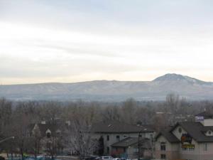 a city with houses and mountains in the background at American Motel in Wheat Ridge