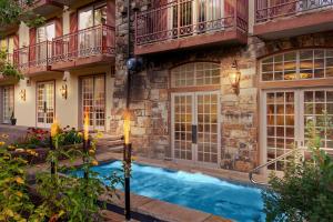a house with a swimming pool in front of a building at Tivoli Lodge in Vail
