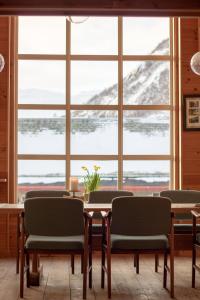 a dining room with a table and chairs and a large window at Voss Mountain Lodge in Mjølfjell