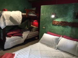 a bedroom with two bunk beds and a bed at Shanti Lodge in Bangkok
