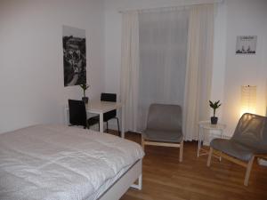 a bedroom with a bed and a table and chairs at rooms lux city in Luxembourg