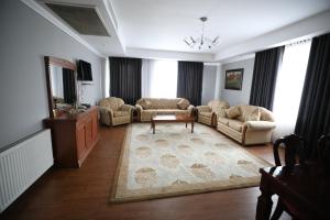 Area soggiorno di Bokhtar Apart Hotel