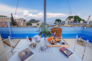 a table on a boat with a tray of food at Gregos Rooftop Suite City Center w. Sea View in Corfu Town