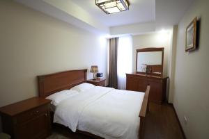 Letto o letti in una camera di Bokhtar Apart Hotel