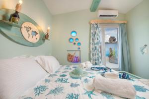 a bedroom with a bed with a hat on it at Gregos Rooftop Suite City Center w. Sea View in Corfu Town