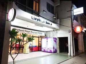 a store front of a building with a red traffic light at Elephant House Themed Hotel in George Town