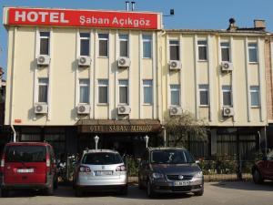 a hotel with cars parked in front of a building at Saban Acikgoz Hotel in Edirne