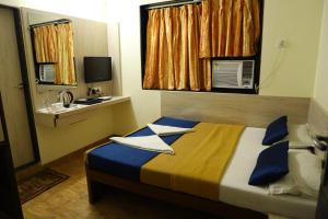 Säng eller sängar i ett rum på Hotel Alka Residency