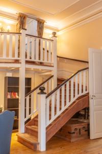 a spiral staircase in a home with wooden floors at Wanha Kartano in Kokkola