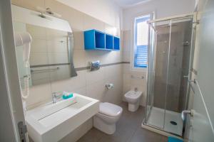 a bathroom with a sink and a toilet and a shower at B&B Aria di Mare in San Vito lo Capo