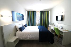 Postel nebo postele na pokoji v ubytování Hotel Santana
