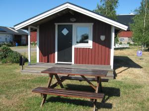 una mesa de picnic frente a una casita en Rödlix Vandrarhem & Camping en Tvååker