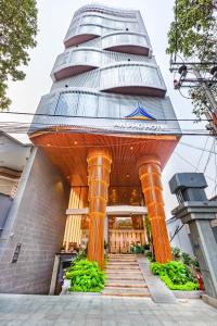 a building with orange columns in front of a building at An Phu Hotel in Phú Quốc