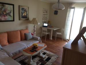 a living room with a couch and a table at Apartman Melody in Sombor